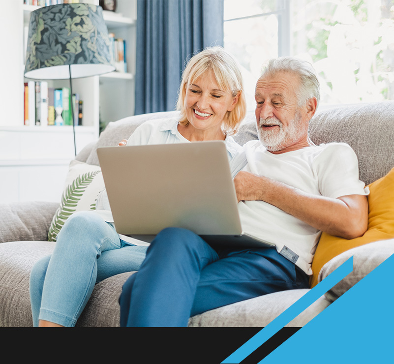smiling woman and man looking at laptop